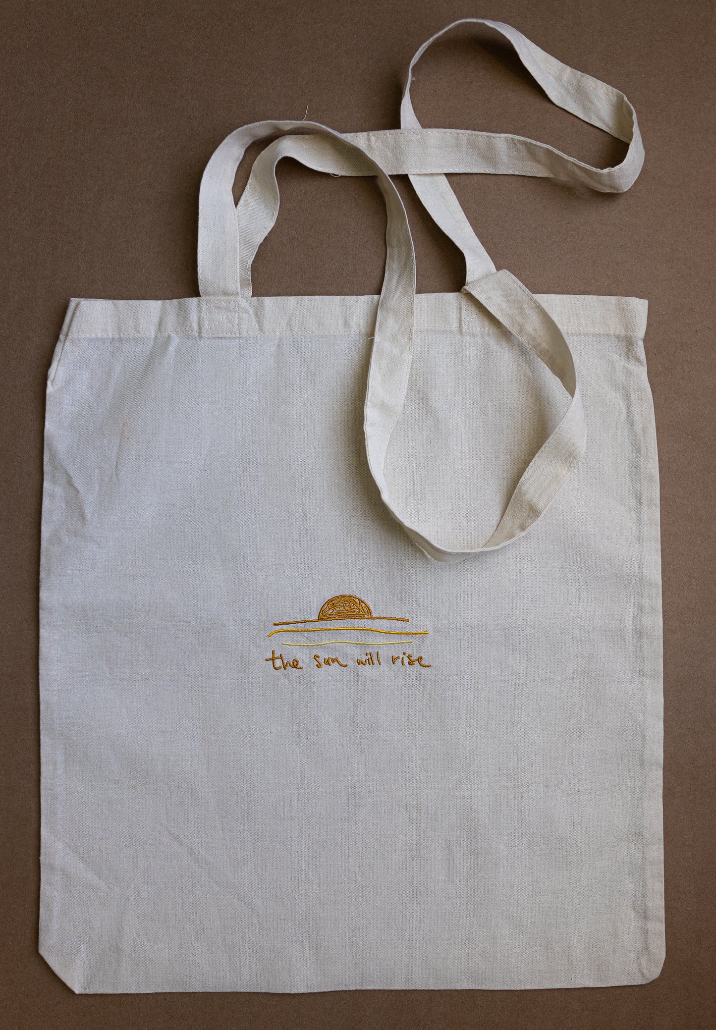 "the sun will rise" tote bag